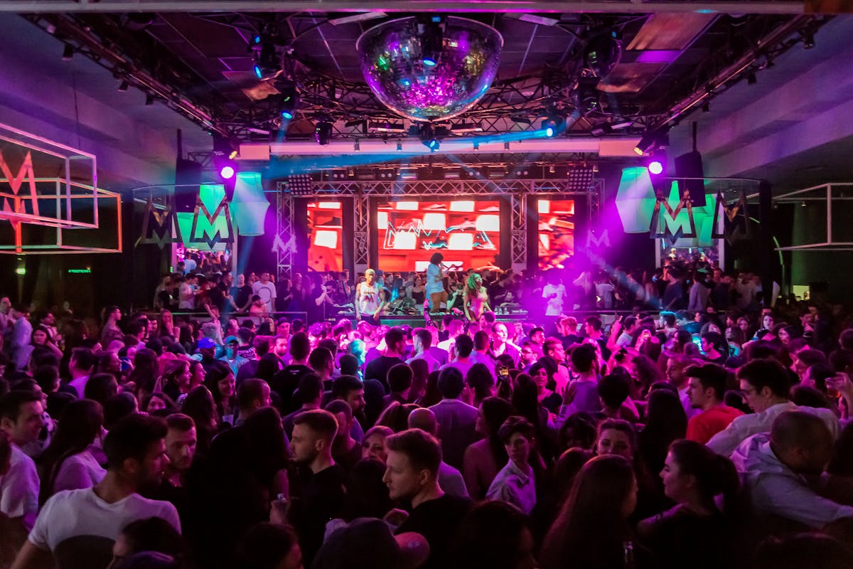 Nightclub crowd under purple stage lights