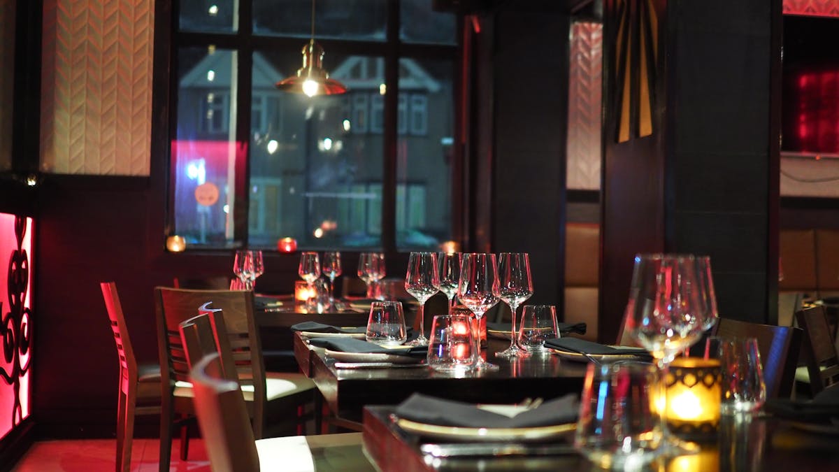 Dim restaurant dining room with set tables