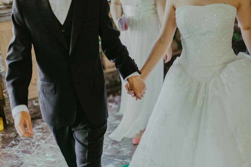Bride and groom holding hands and walking